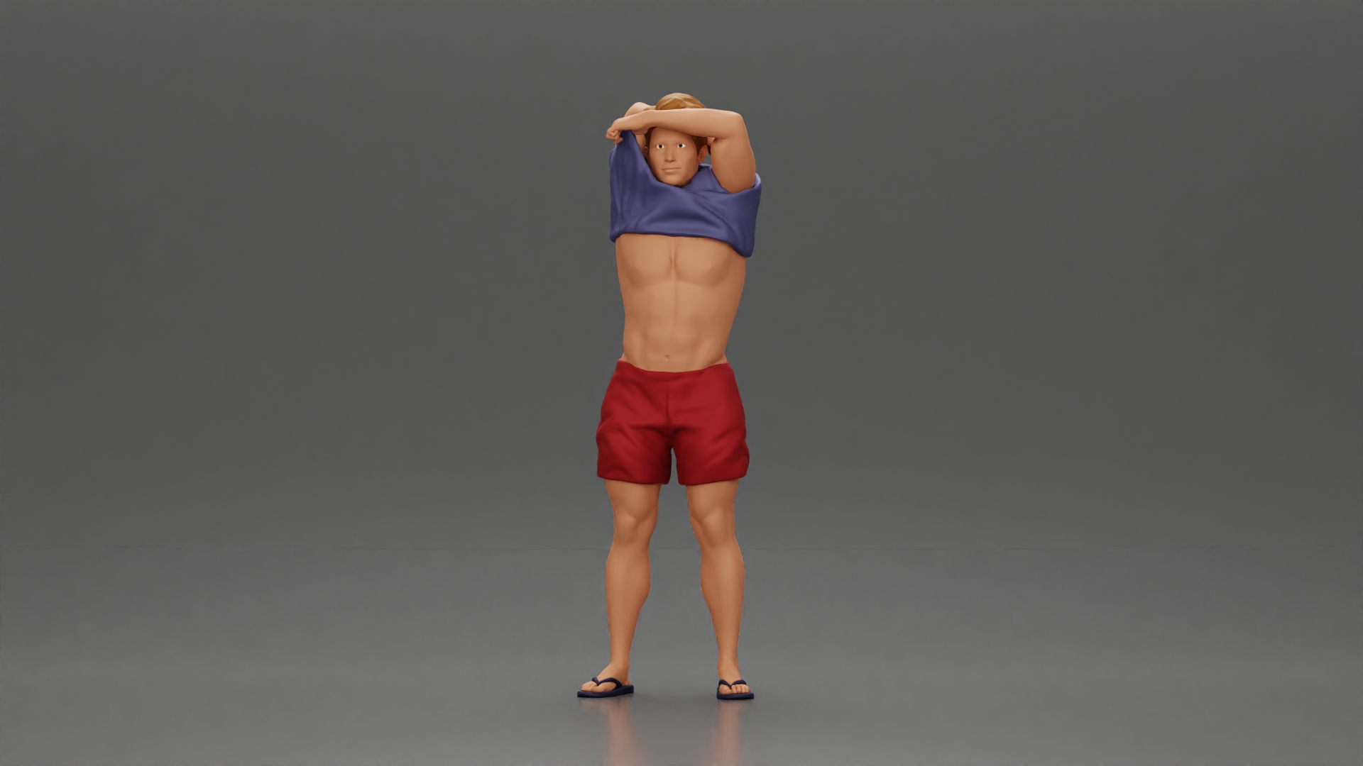 muscular man in shorts taking off his shirt to go swimming
